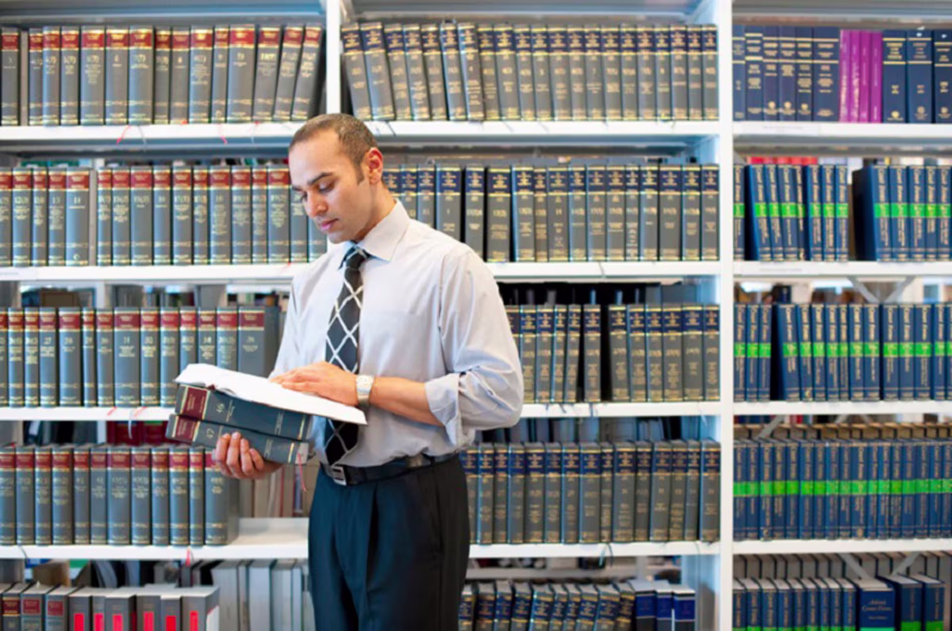 Man reading legal text in law library