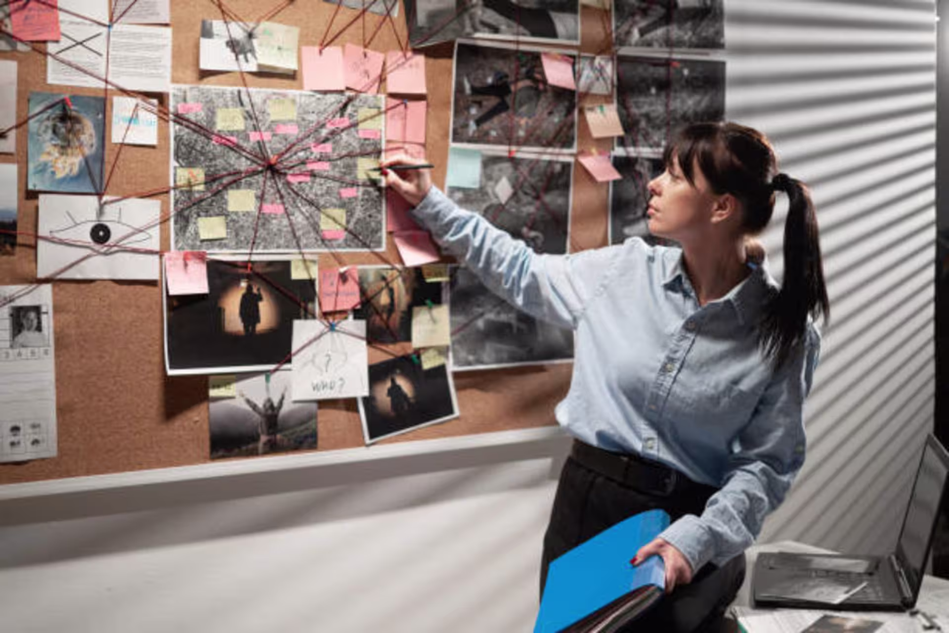 Woman connecting the dots for an investigation.