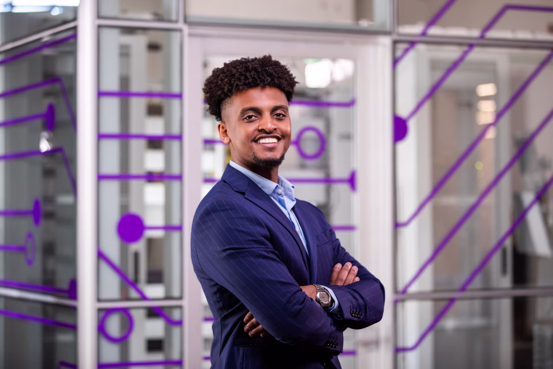 Male BS in Cybersecurity student smiling in conference room