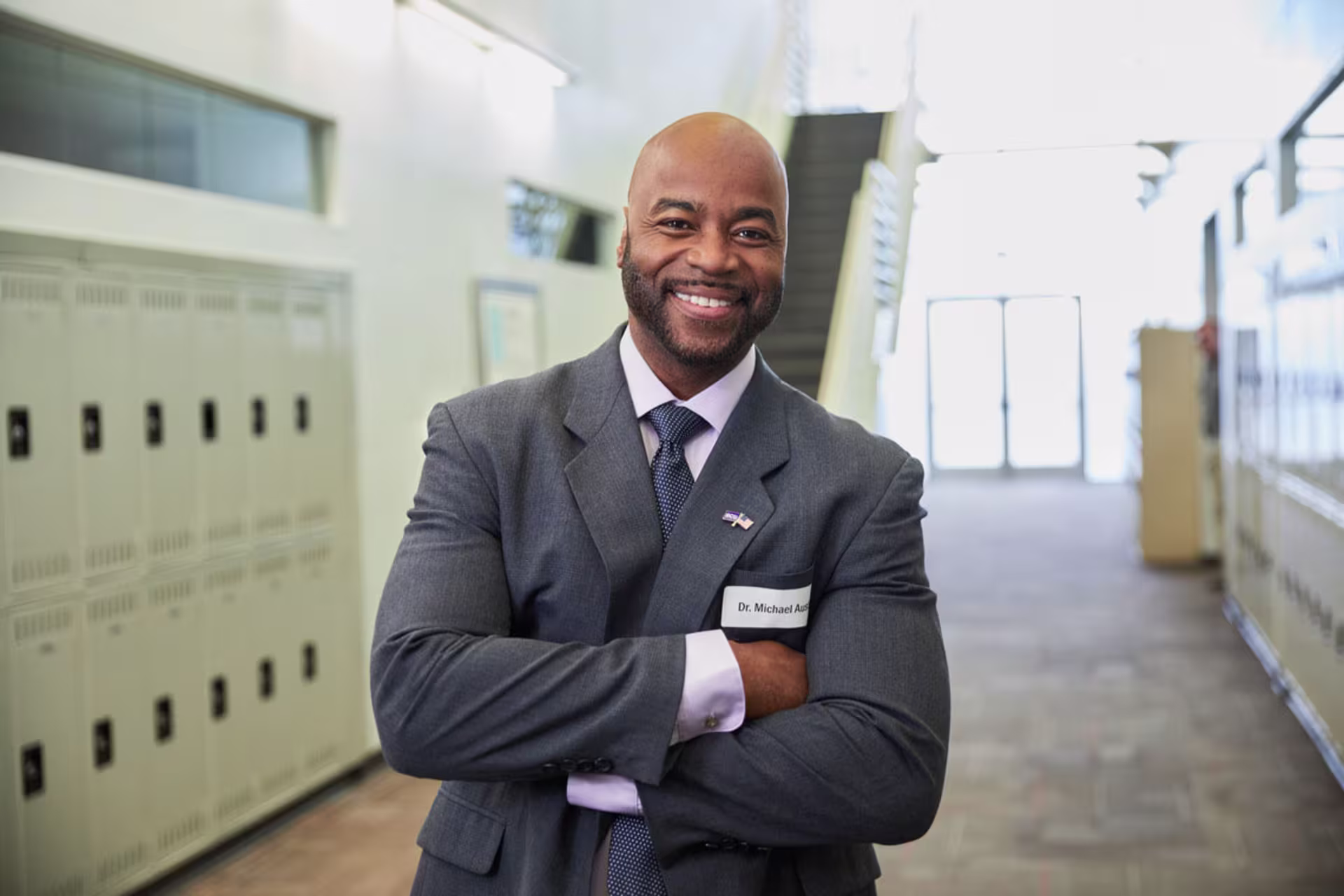 Male CDS professional posing and smiling in hallway