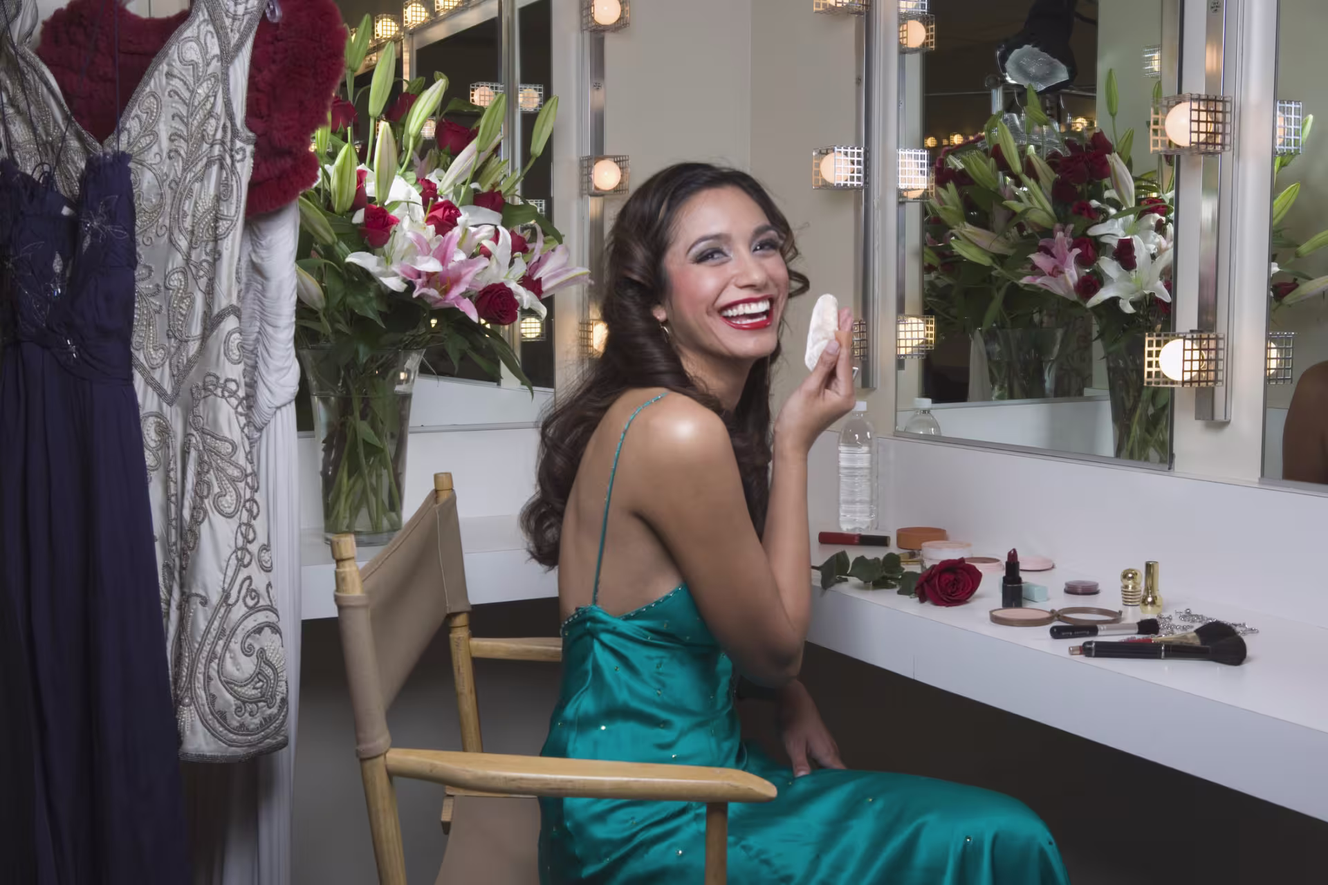 Actress smiles at camera in dressing room
