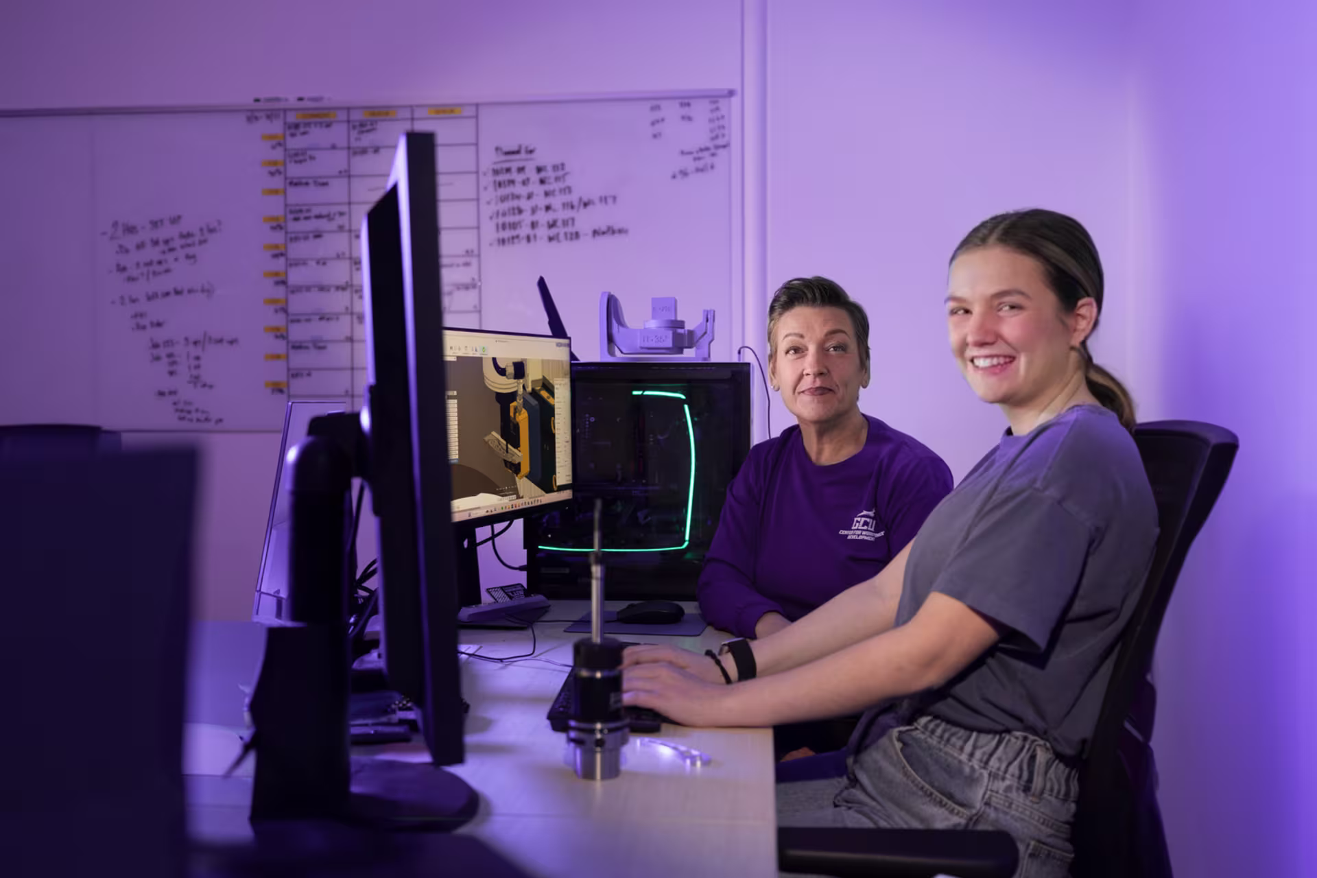 Female tech major working in computer lab with female instructor