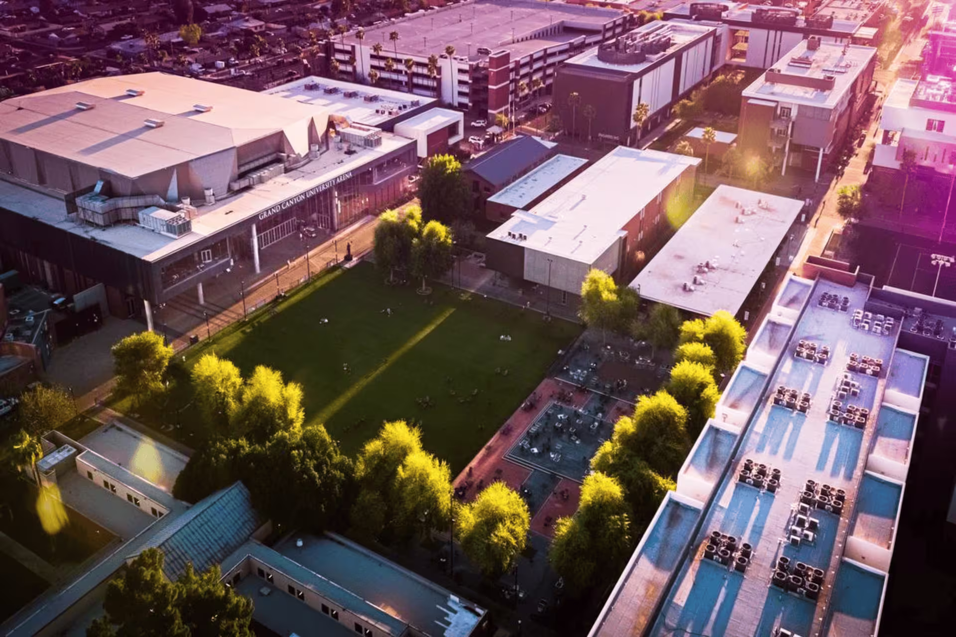 Overhead view of the GCU campus featuring academic buildings, shaded walkways and a central green space at sunset.