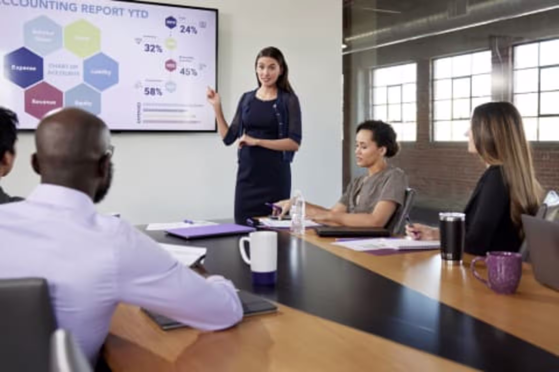 Female Business Analytics student showcasing work on screen in front of students