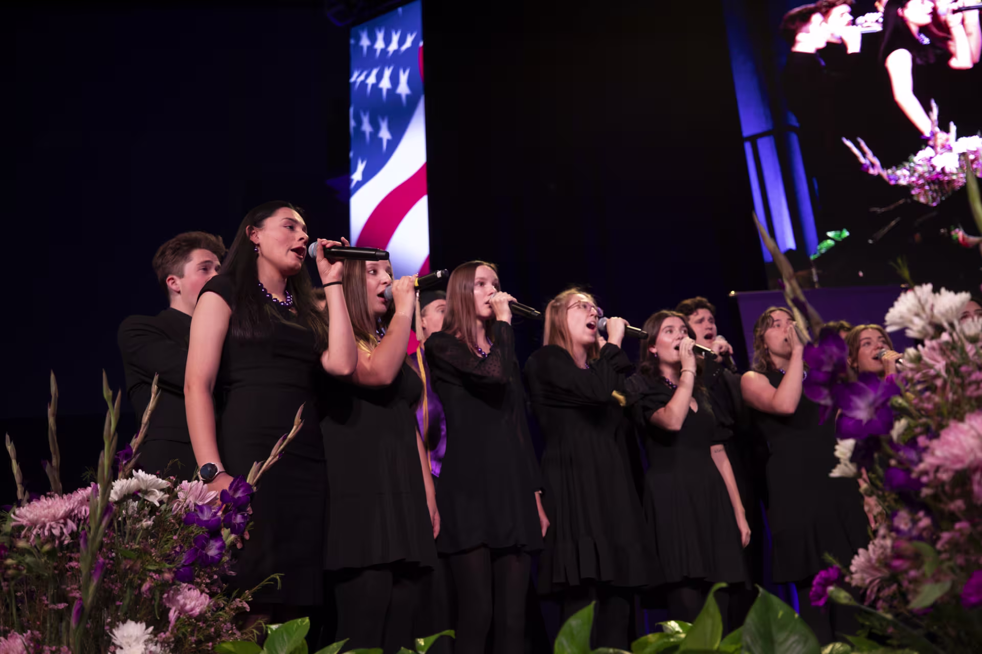 GCU choir performing a song with american flag in background