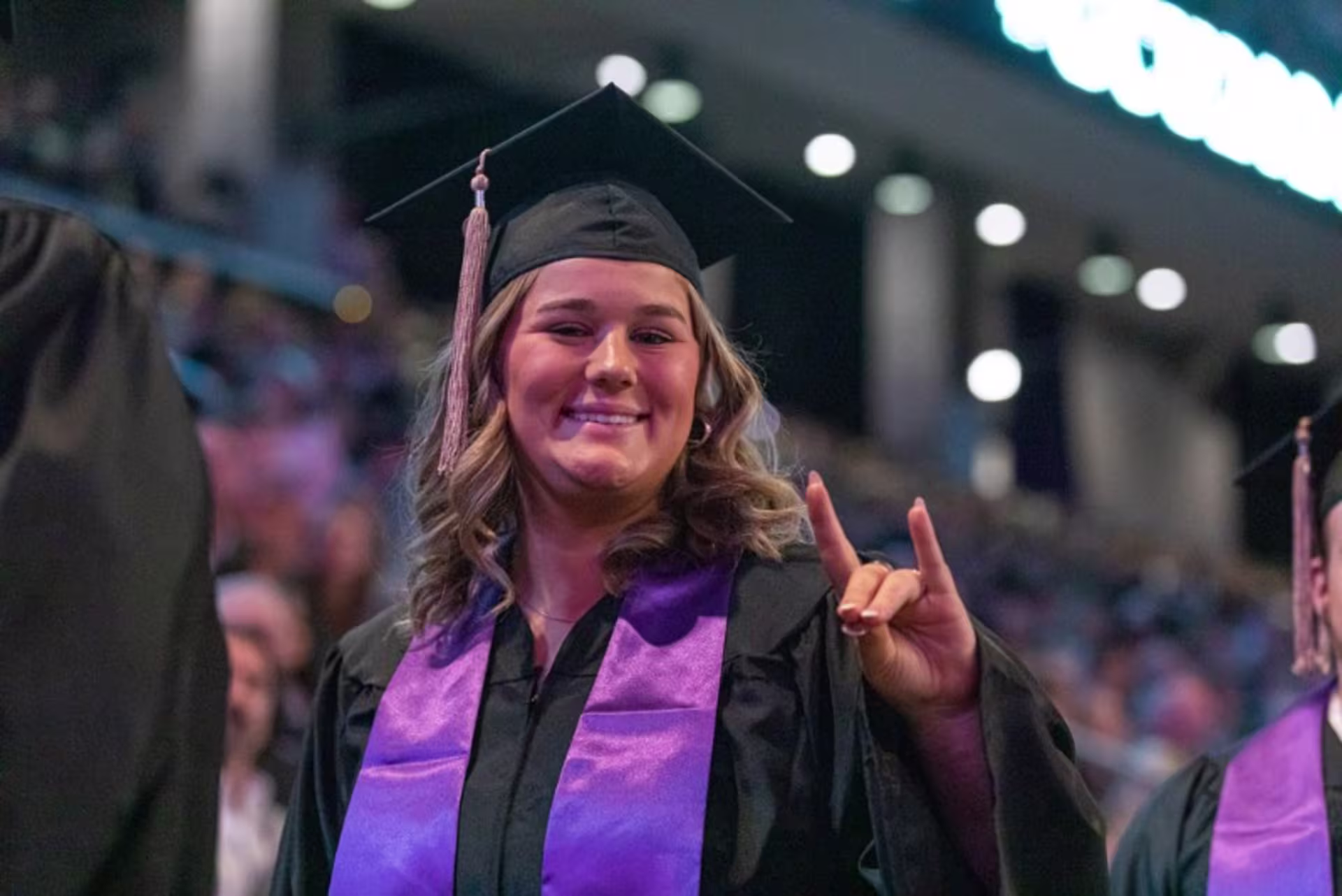 GCU student in graduation cap and gown at graduation ceremony