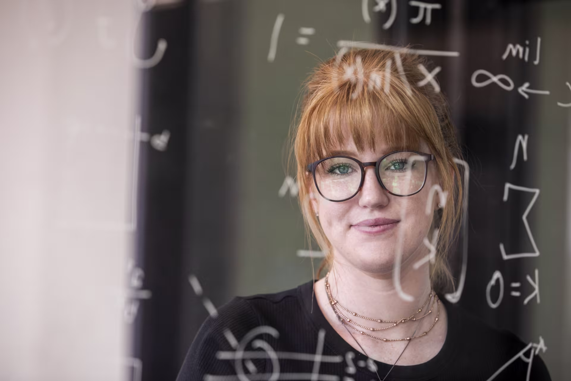 woman-glasses-solving-math-equations-on-board