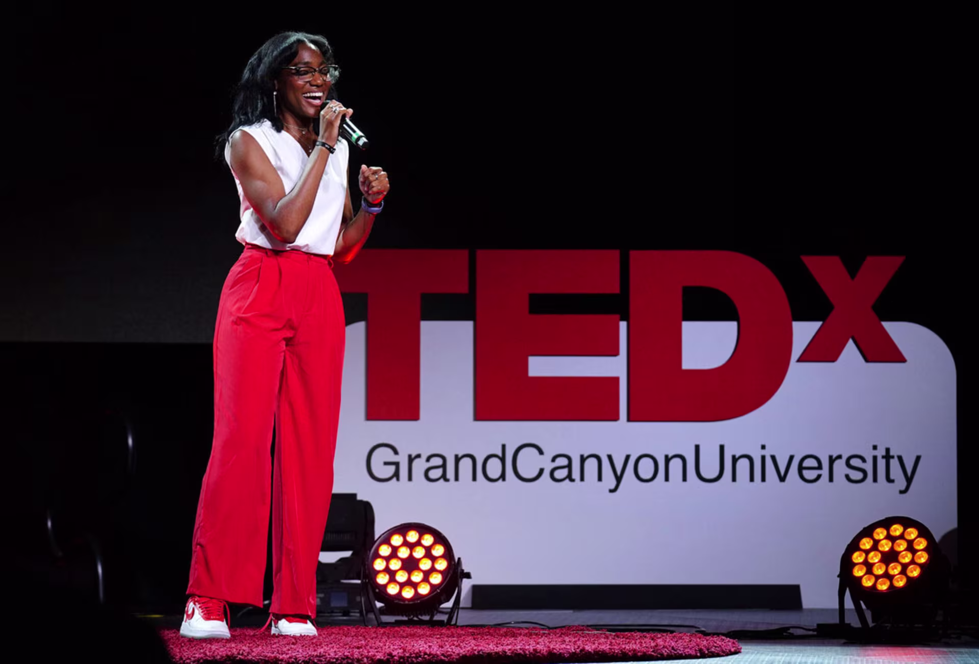 Female marketing professional giving TEDx presentation at GCU