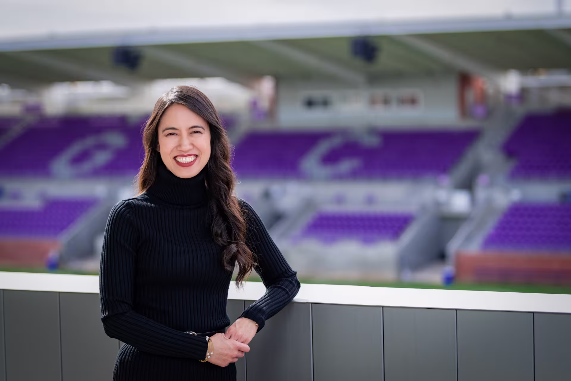 woman sports management posing by field