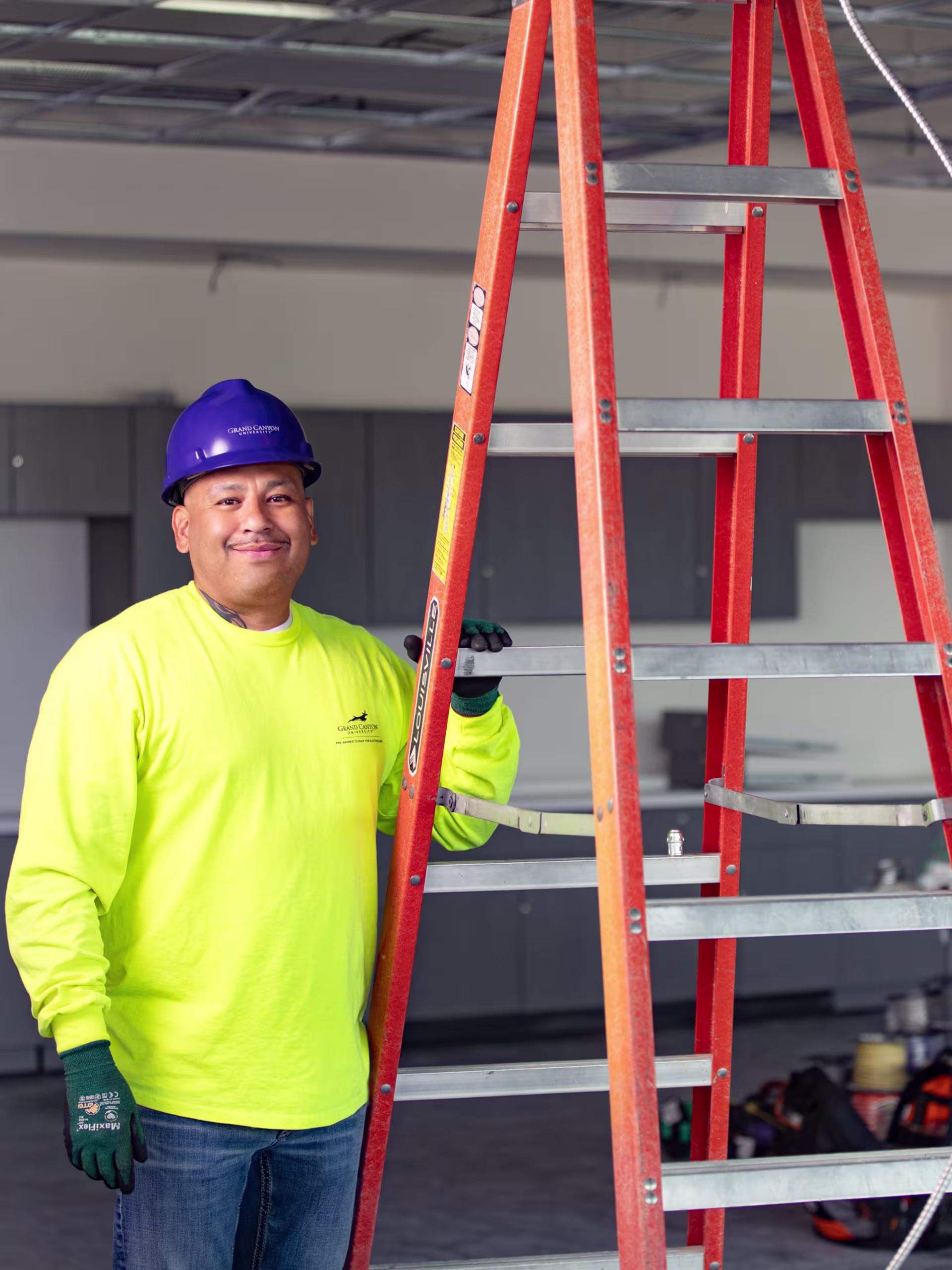 Male GCU student working on industrial wiring for an industrial electrician project.