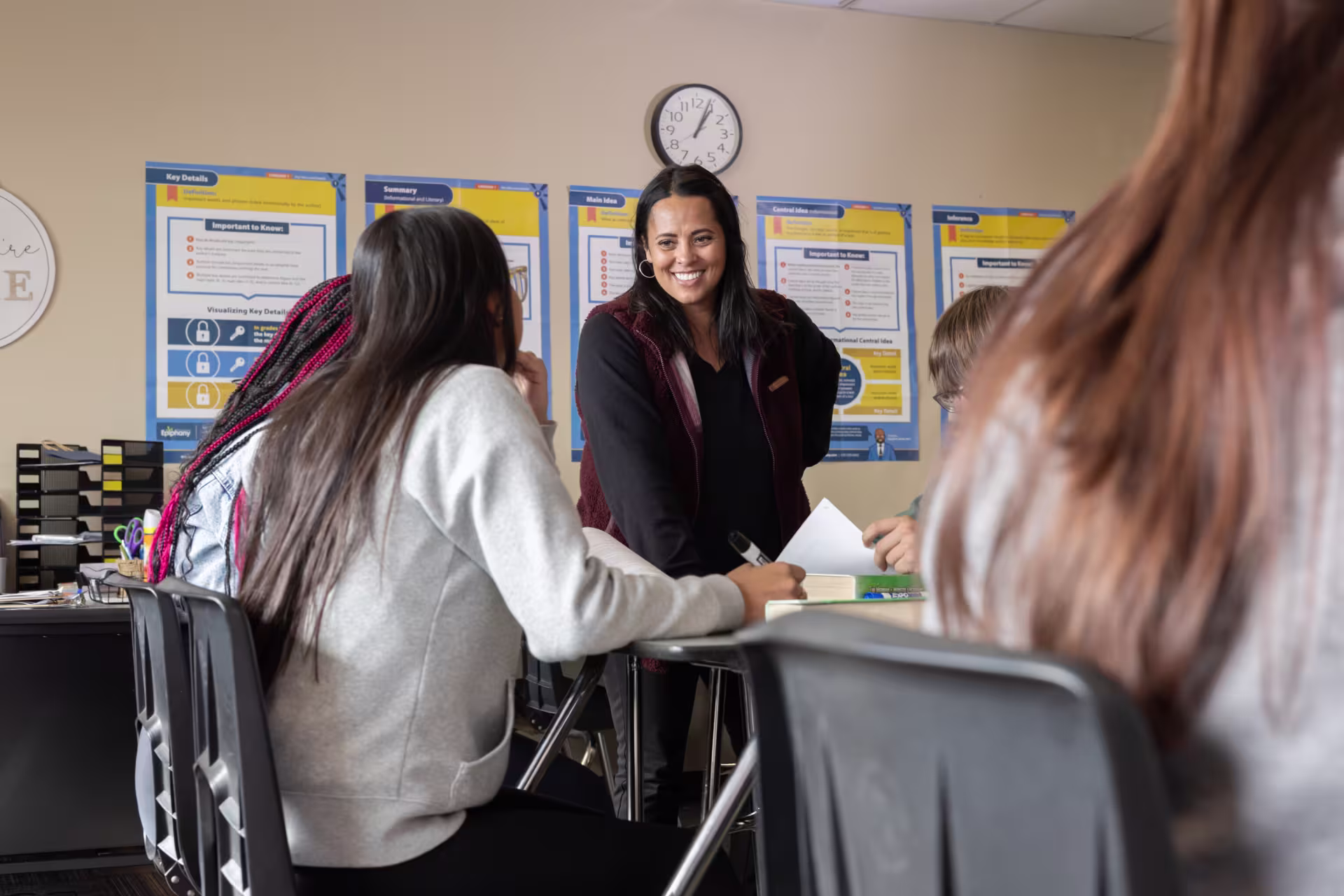 High school teacher smiling at students