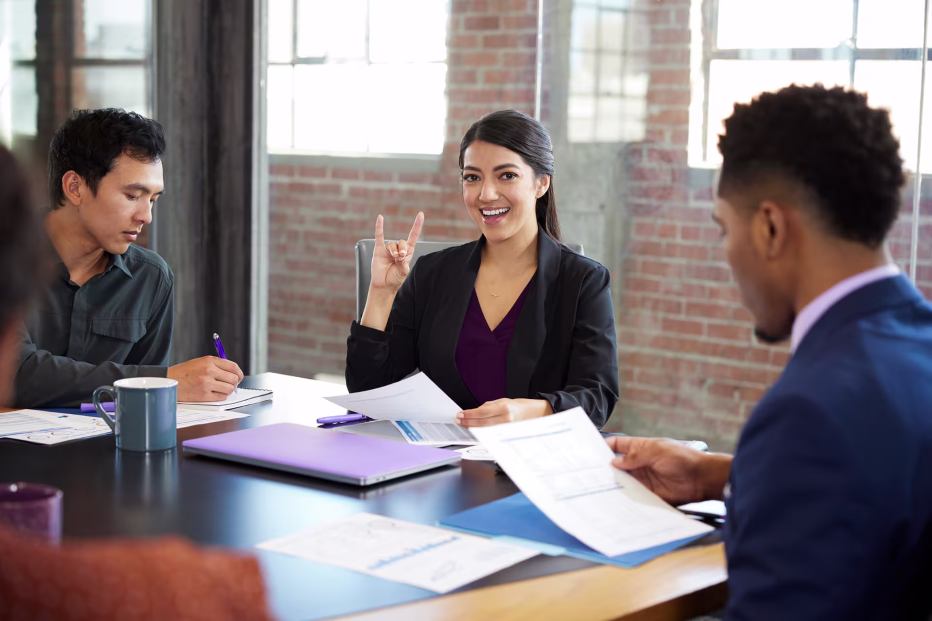 Female legal studies student smiling in study room with peers