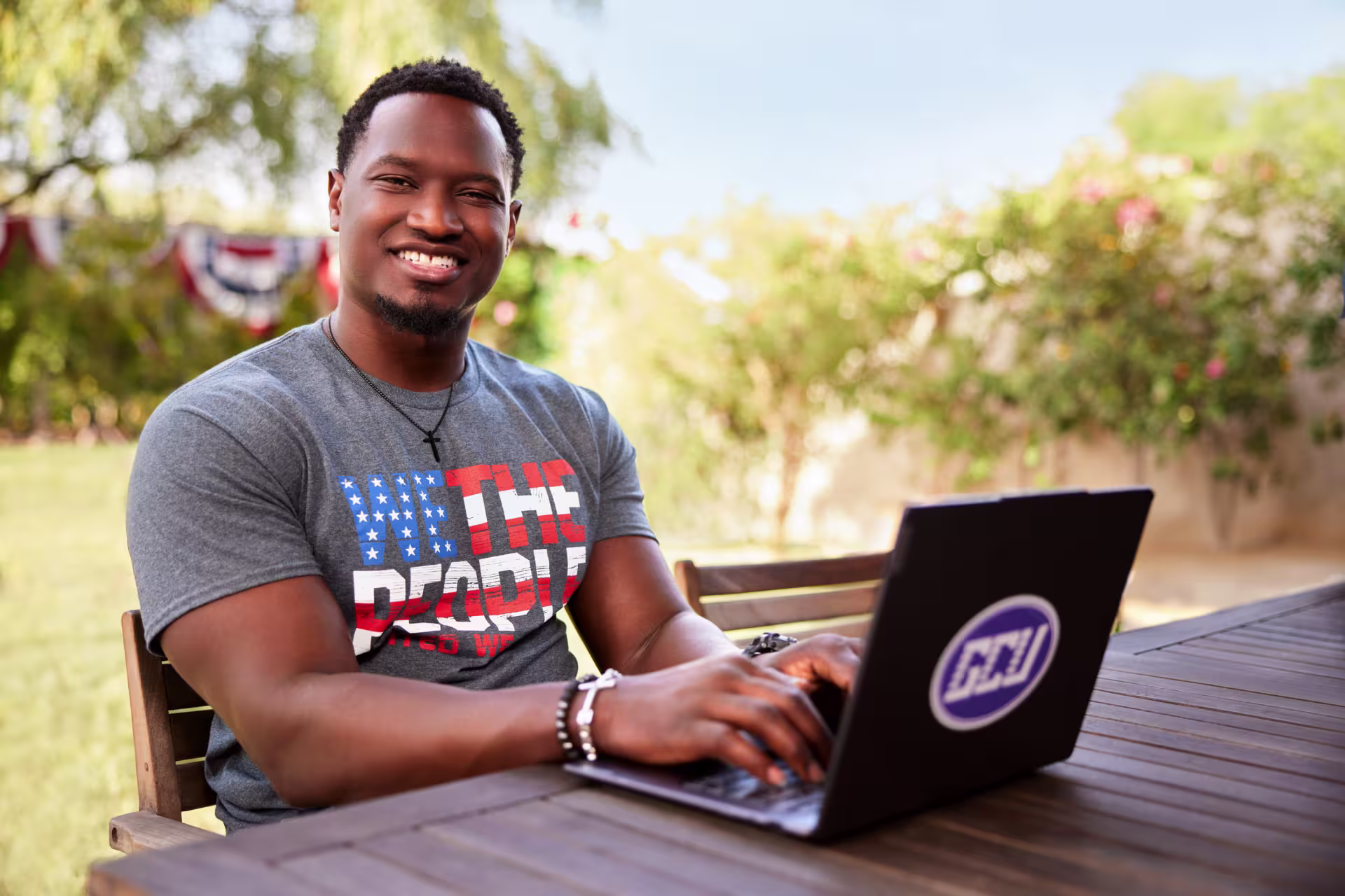 Male army veteran completing online degree in backyard