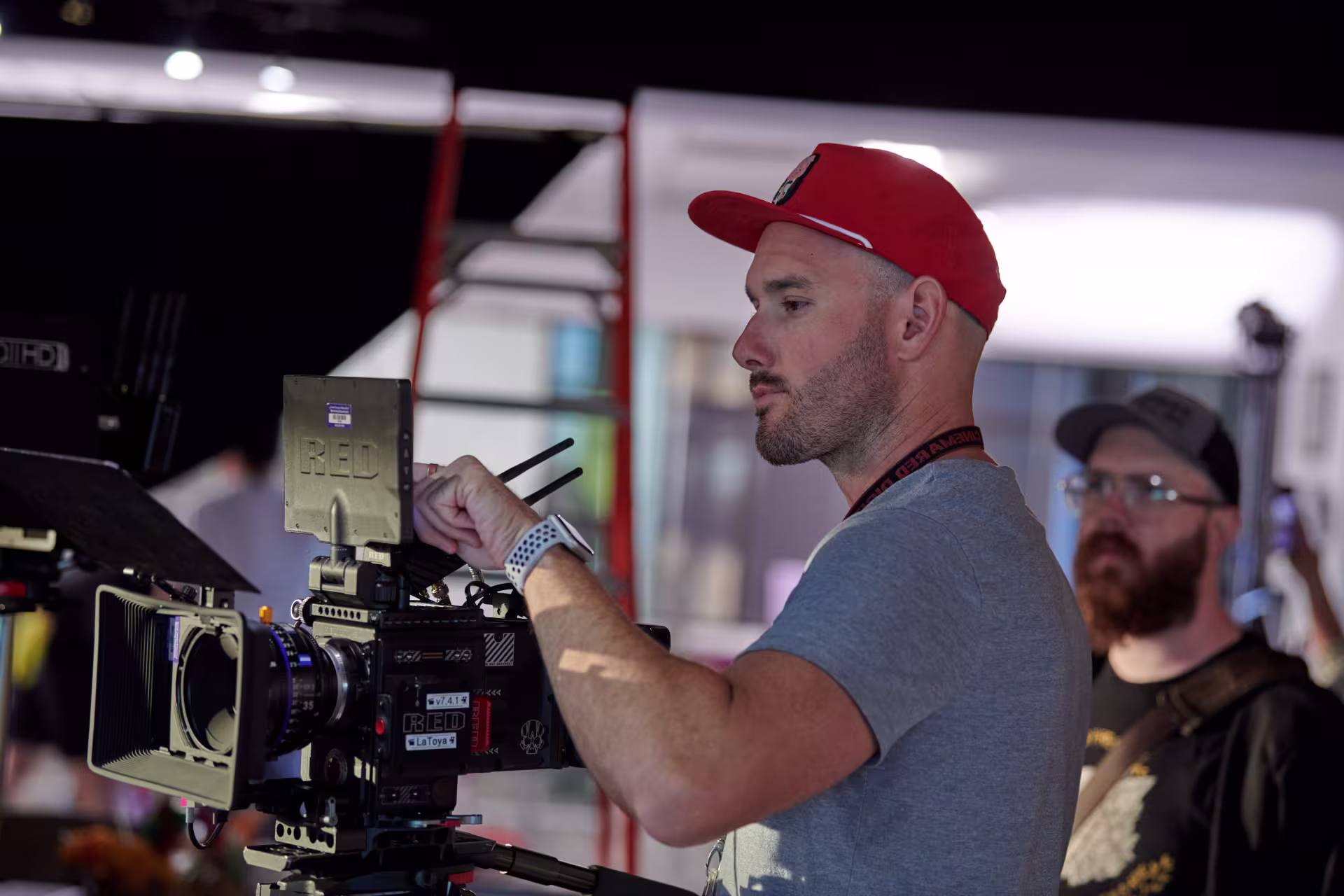 Man adjusting digital film camera