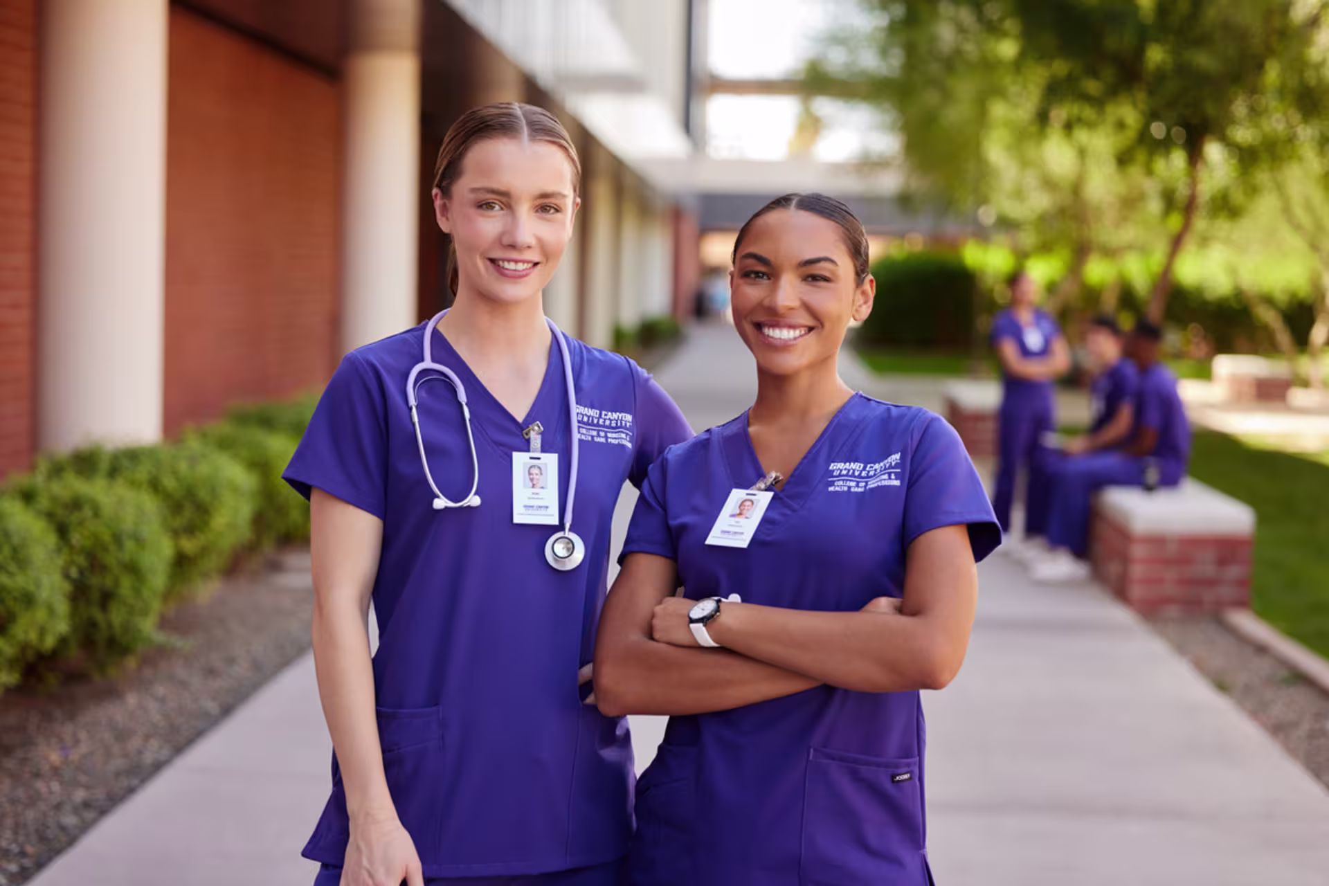 Nursing students in scrubs standing outside a healthcare training facility.
