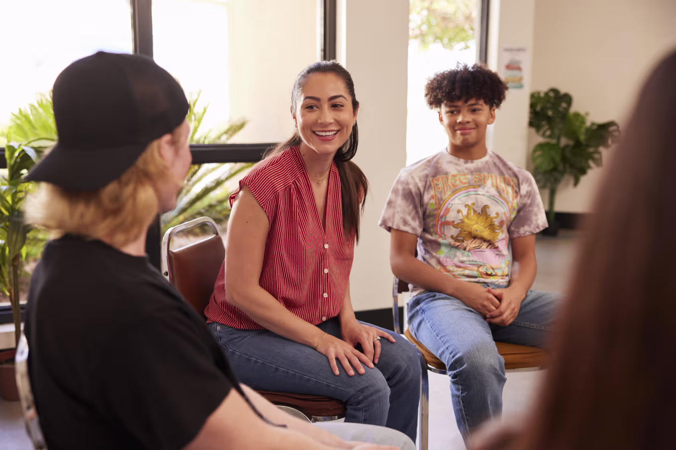 Female instructor talking in group circle with BSW majors in classroom