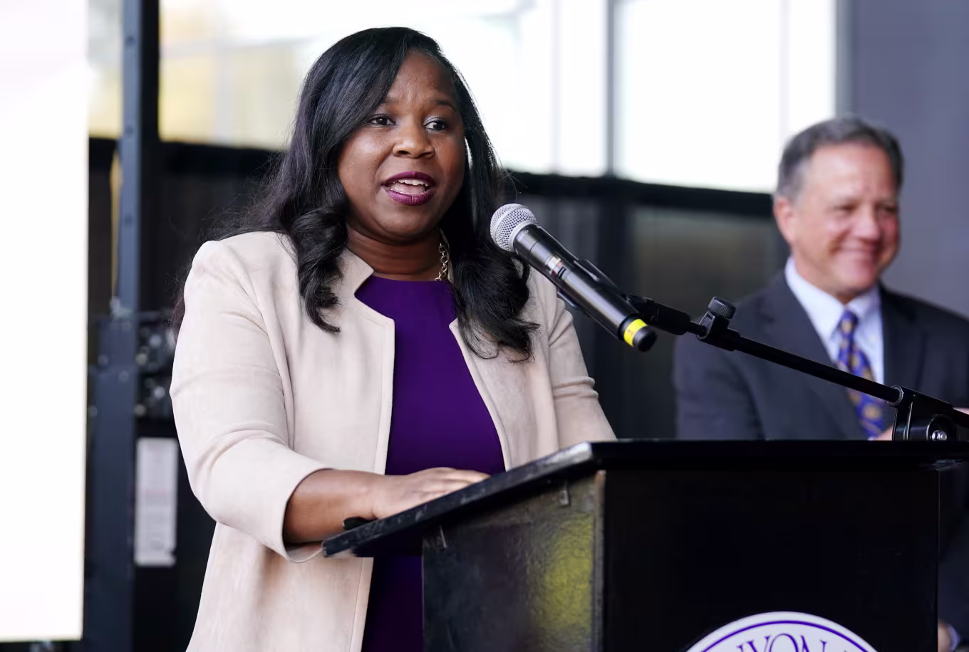 Female servant leader speaking at podium