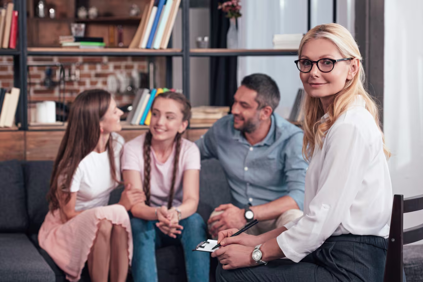 Family Counselor Smiles At Camera During Session