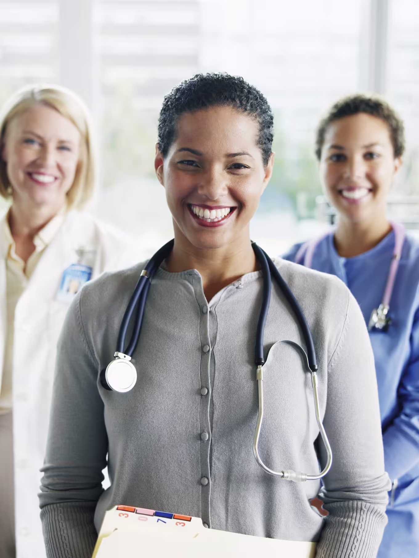 A healthcare professional smiling with medical staff