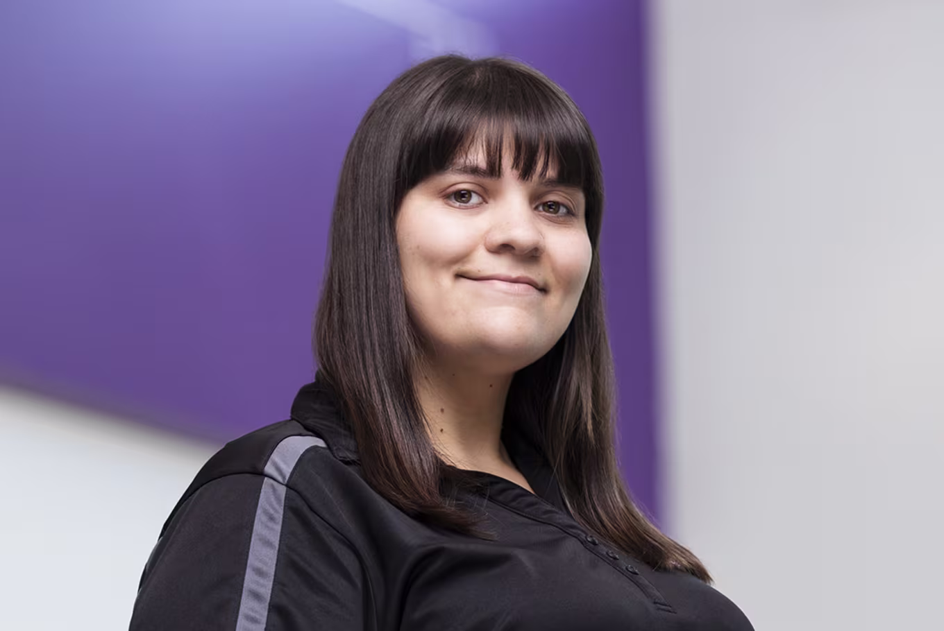 honors program manager Katalina Herrera headshot in black branded tee