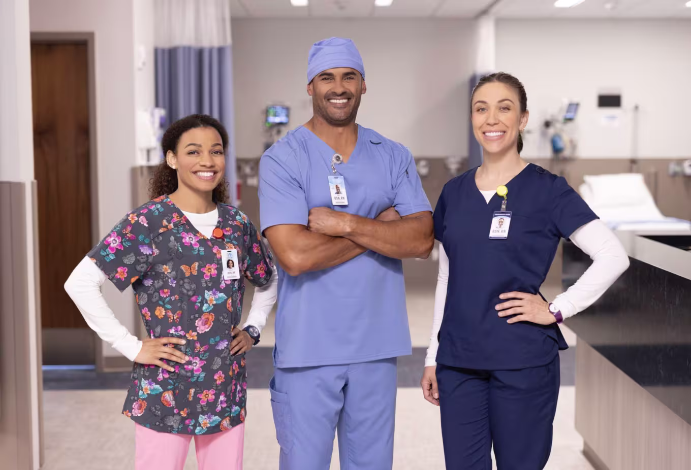 Male and female healthcare professionals smiling together in hospital