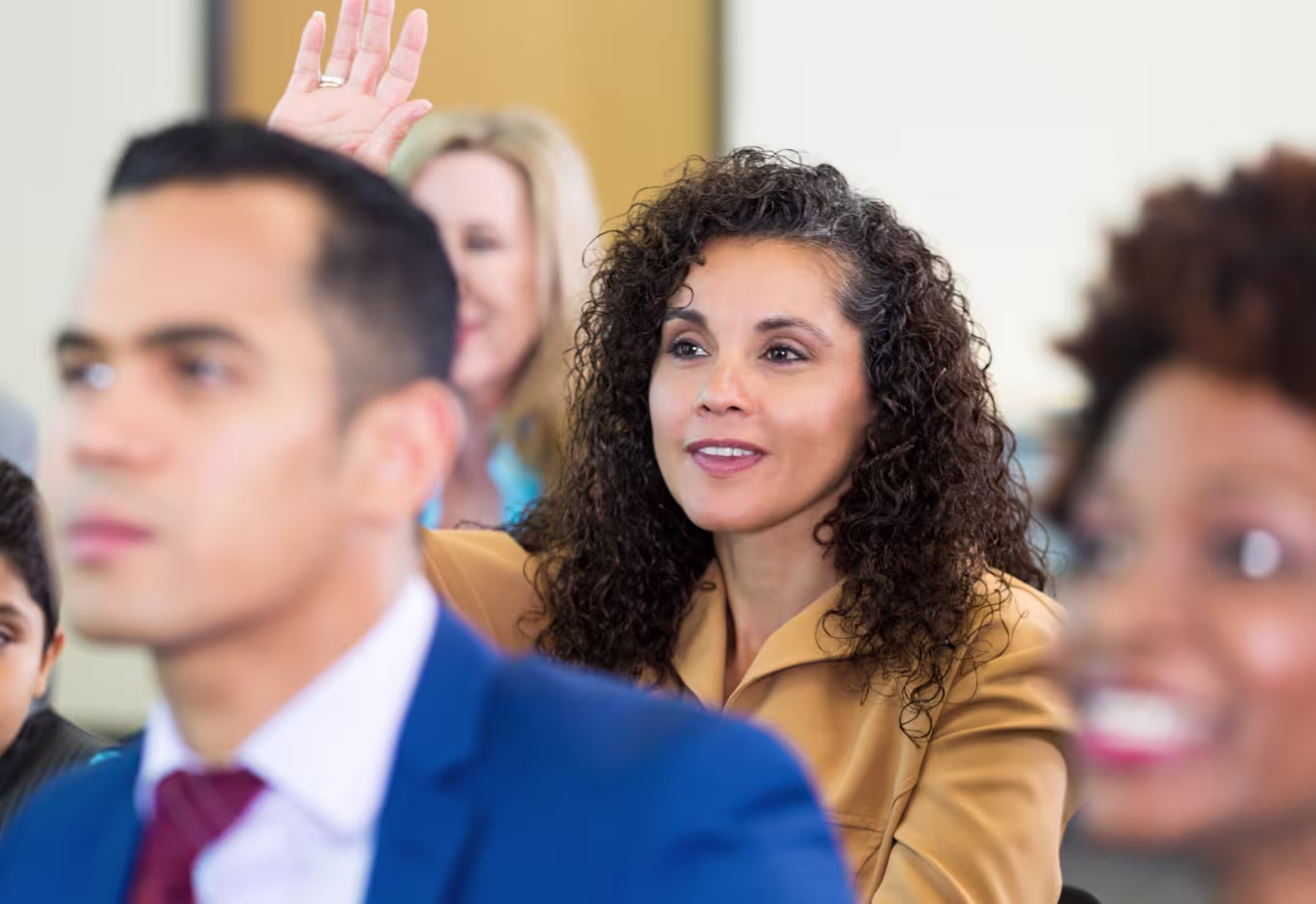 female-public-servant-raises-hand-to-ask-question-at-town-hall-meeting