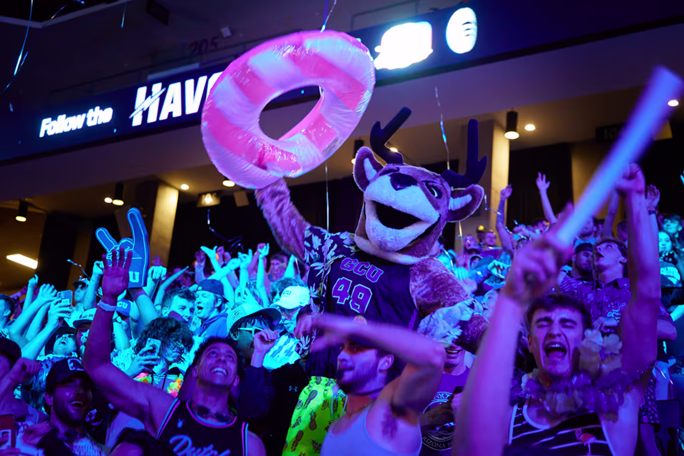 Mascot celebrating with crowd of students