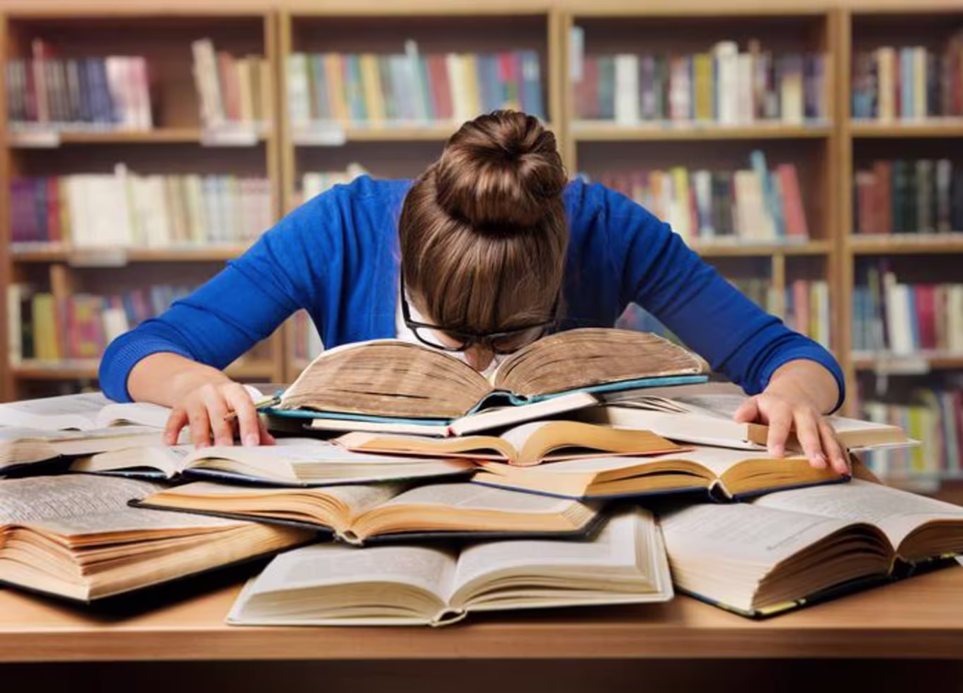 person with head in books