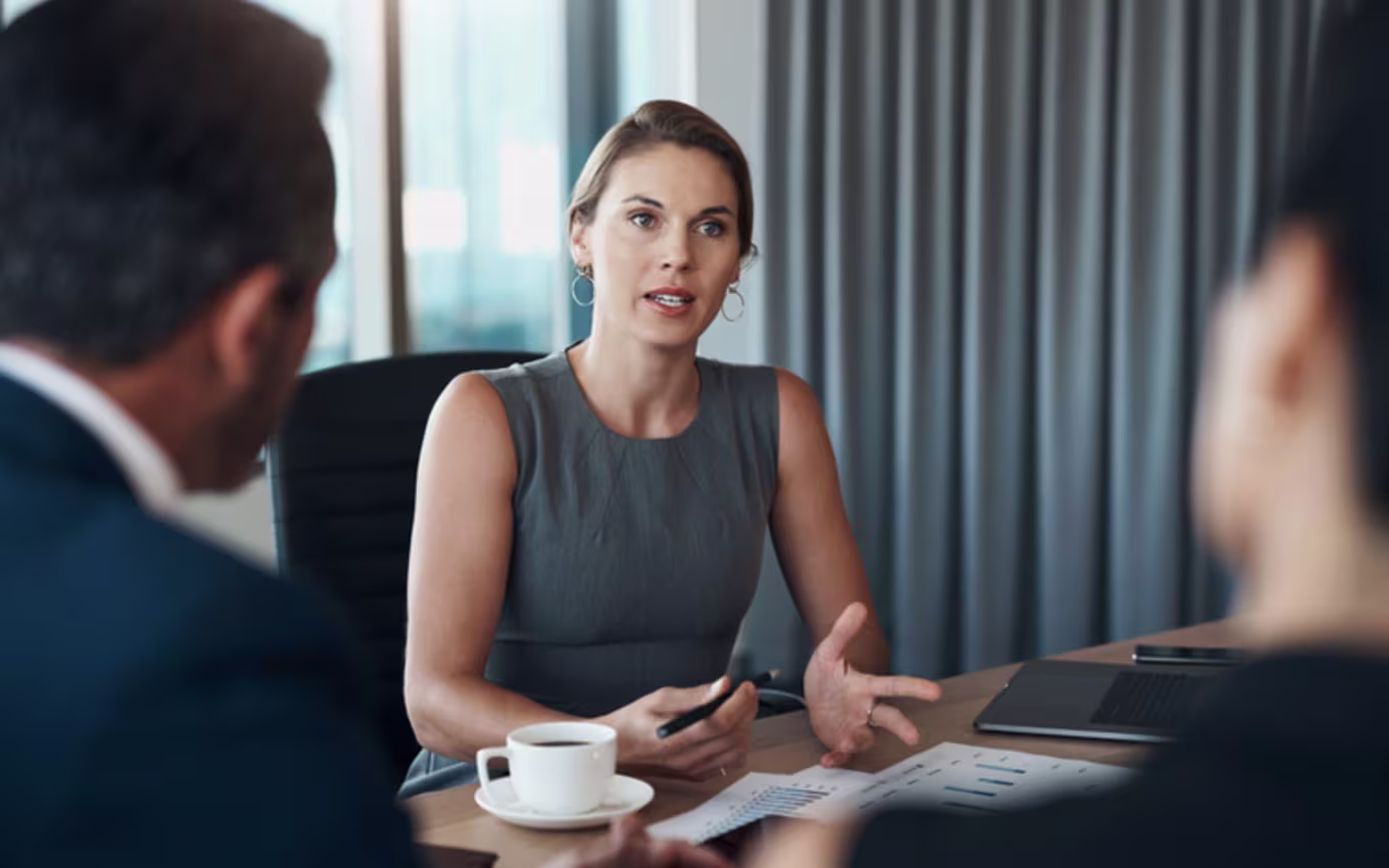 Woman speaks with her coworkers.