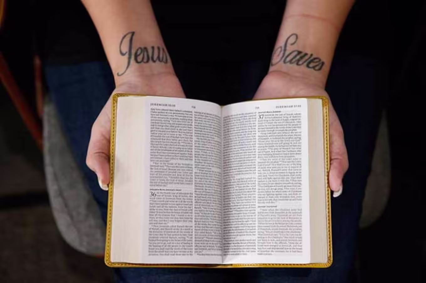 person holding open a bible