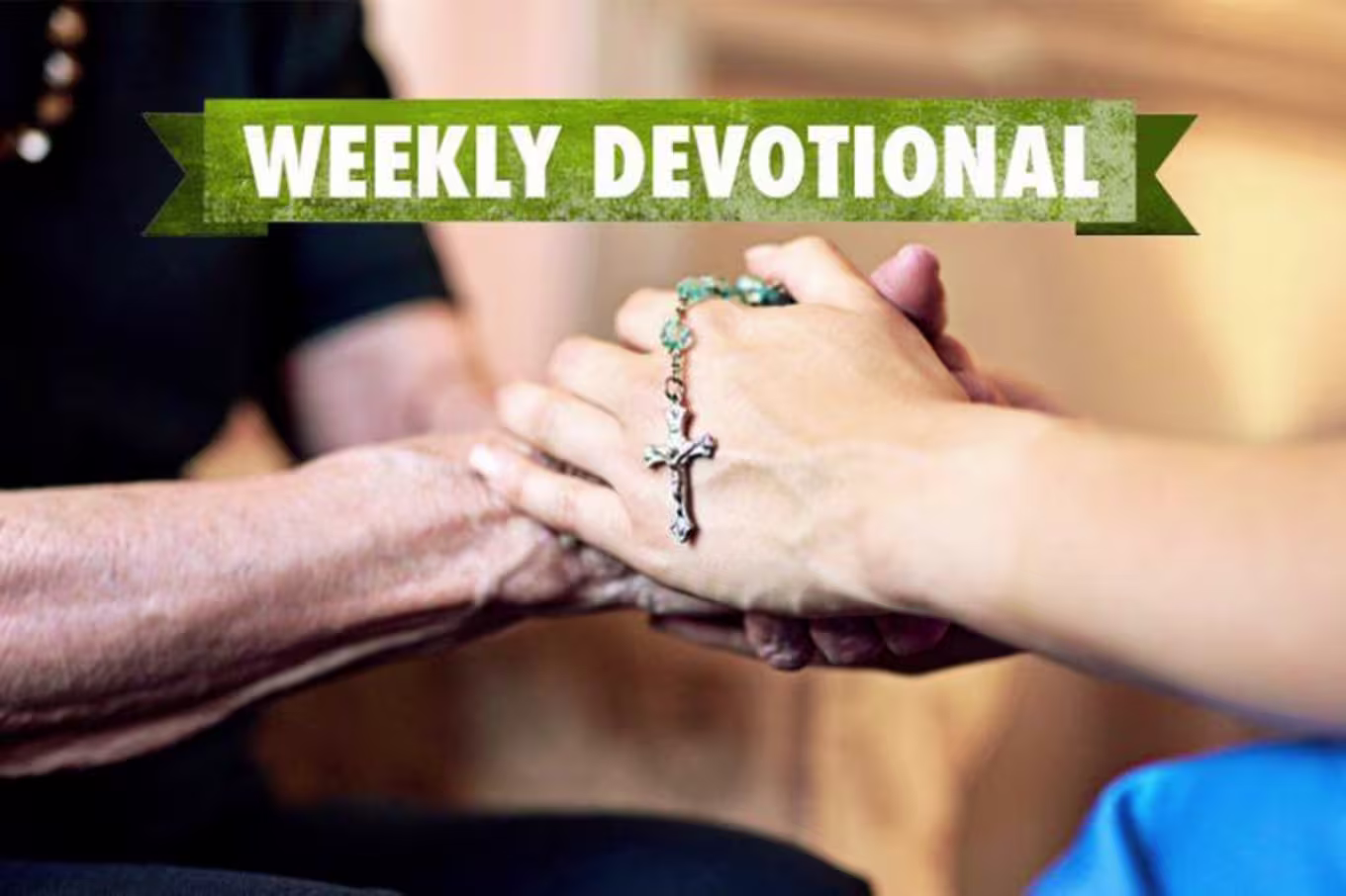 people holding hands with cross pendant on top