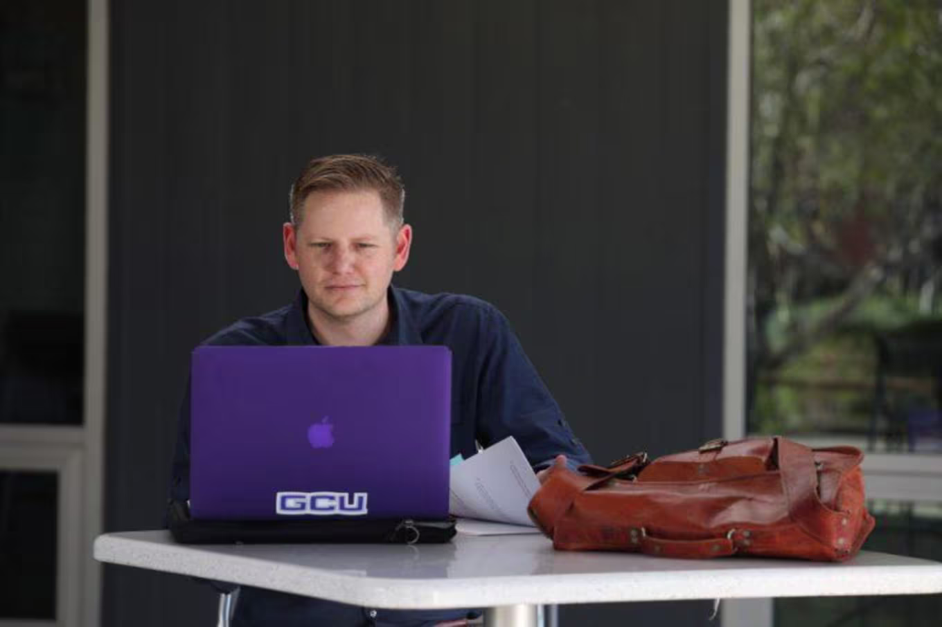 Doctoral learner working on a laptop
