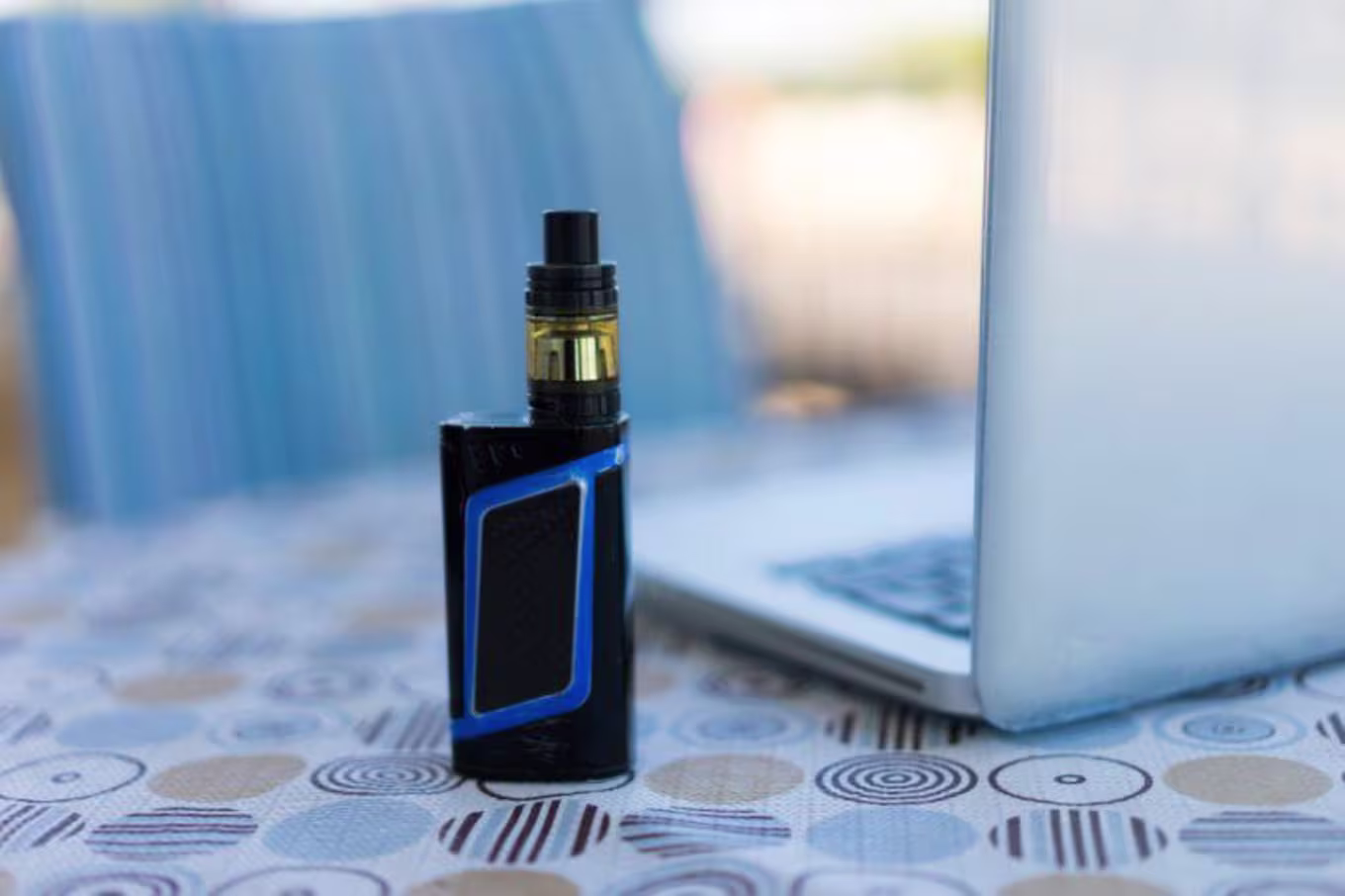 vape pen next to computer