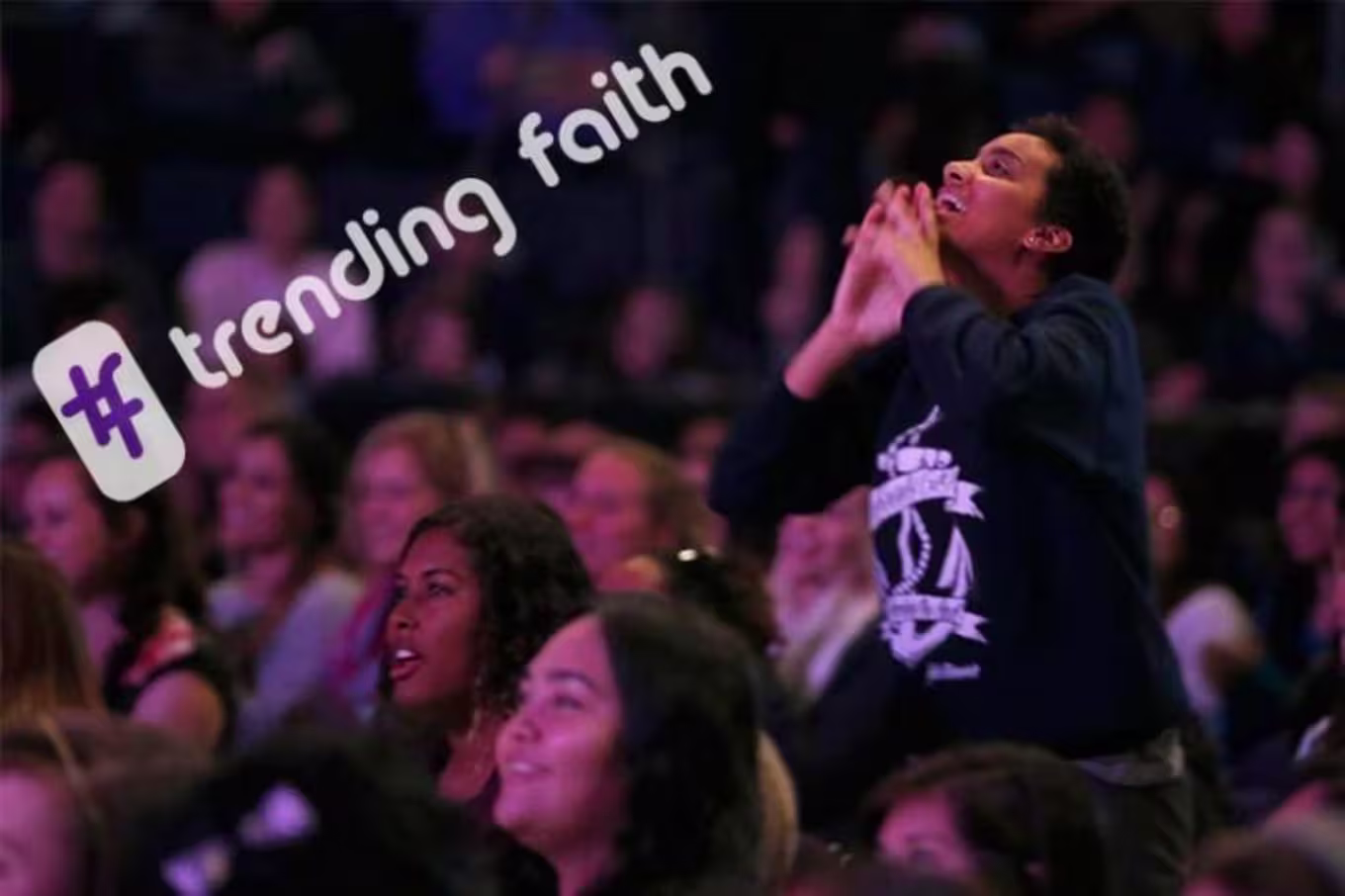 people worshiping in a crowd