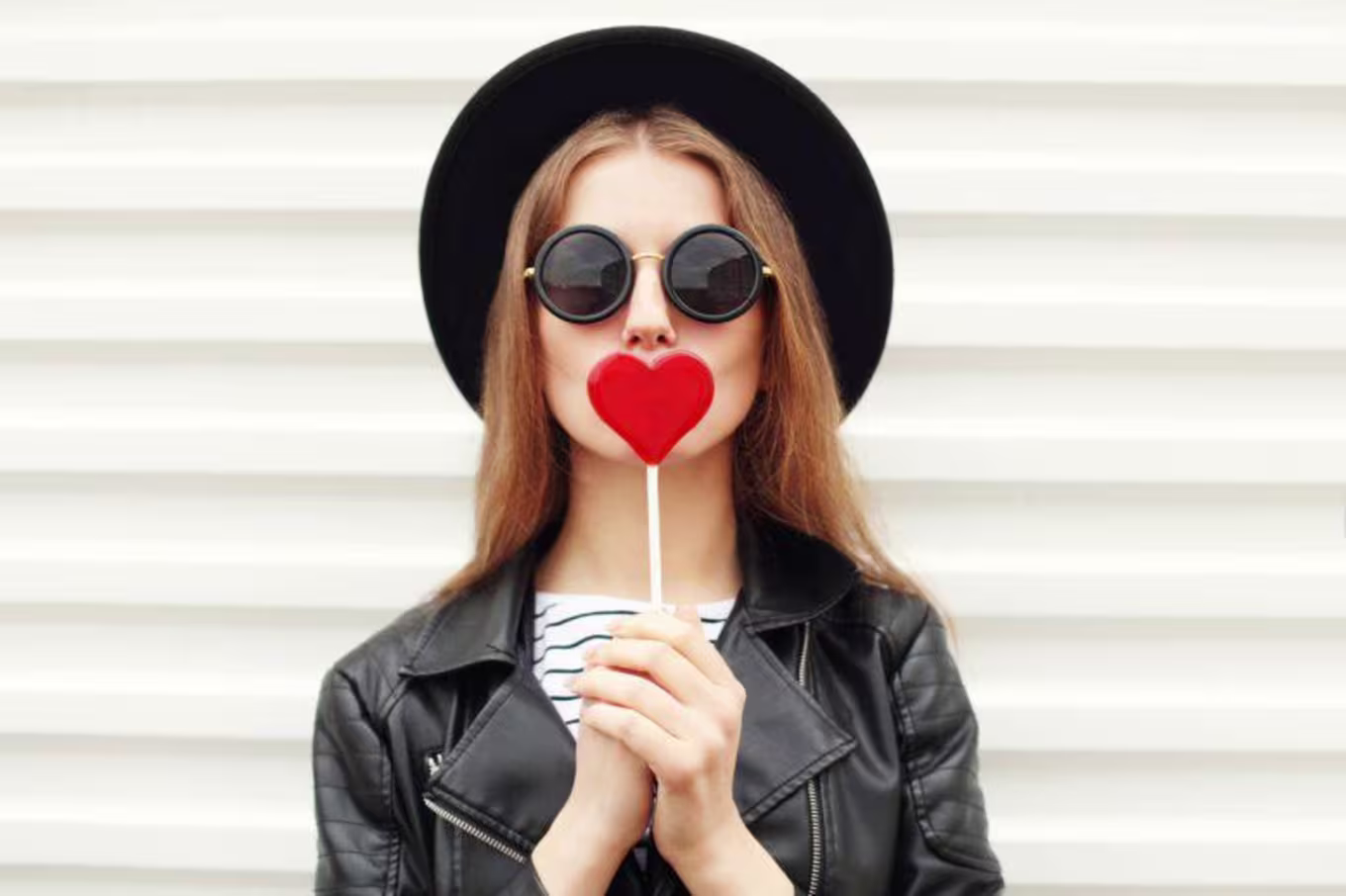 Girl with a heart-shaped lollipop
