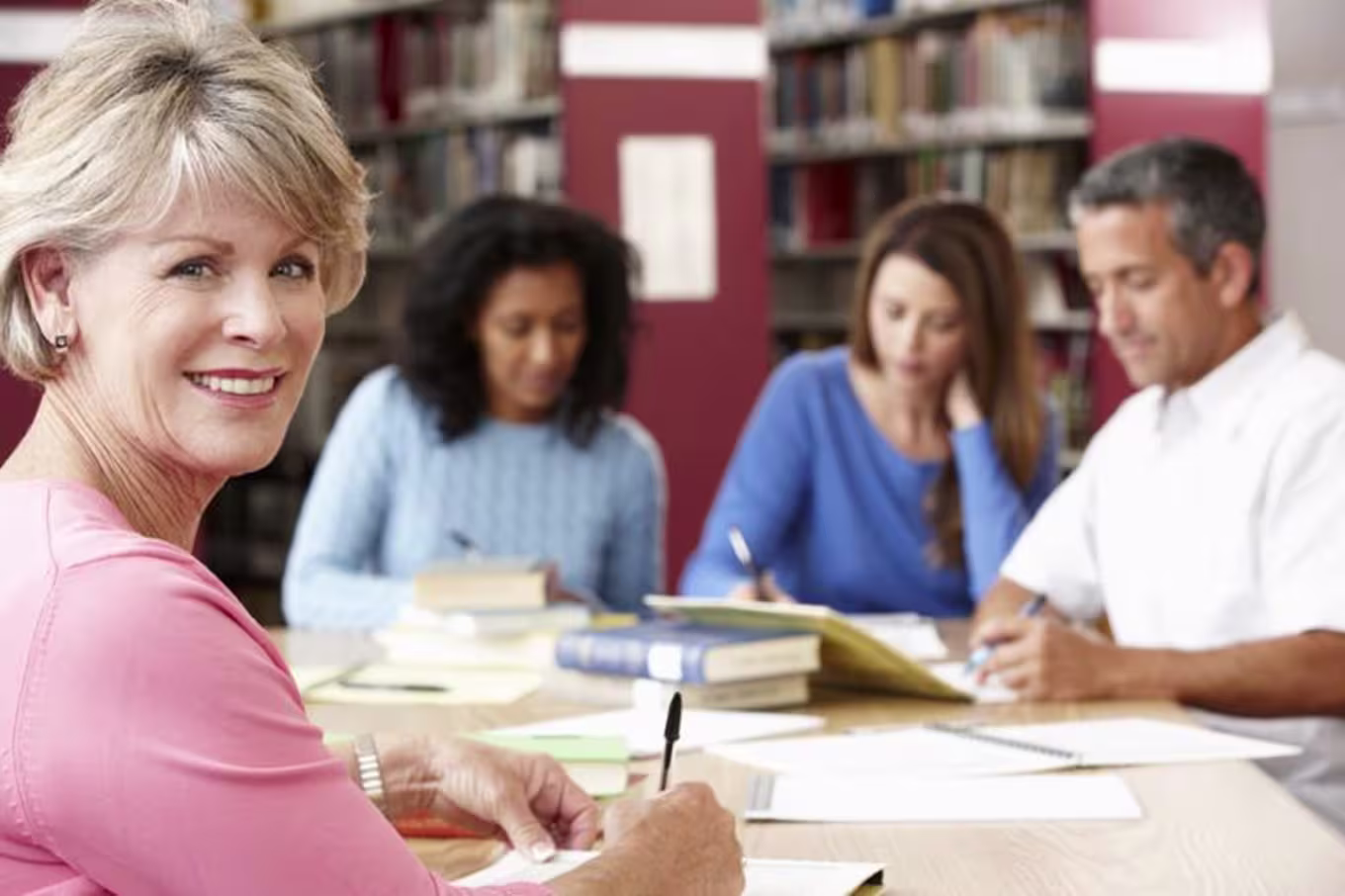 people in the library working together