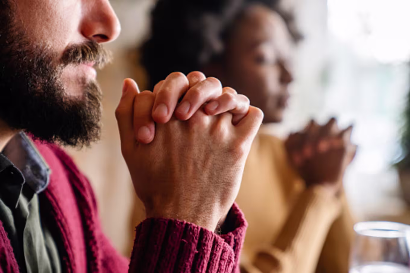 Couple praying before meal as a thankfulness activity