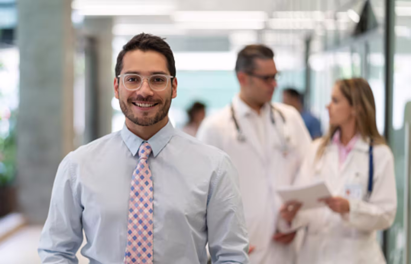 Clinical Manager with doctors in the back