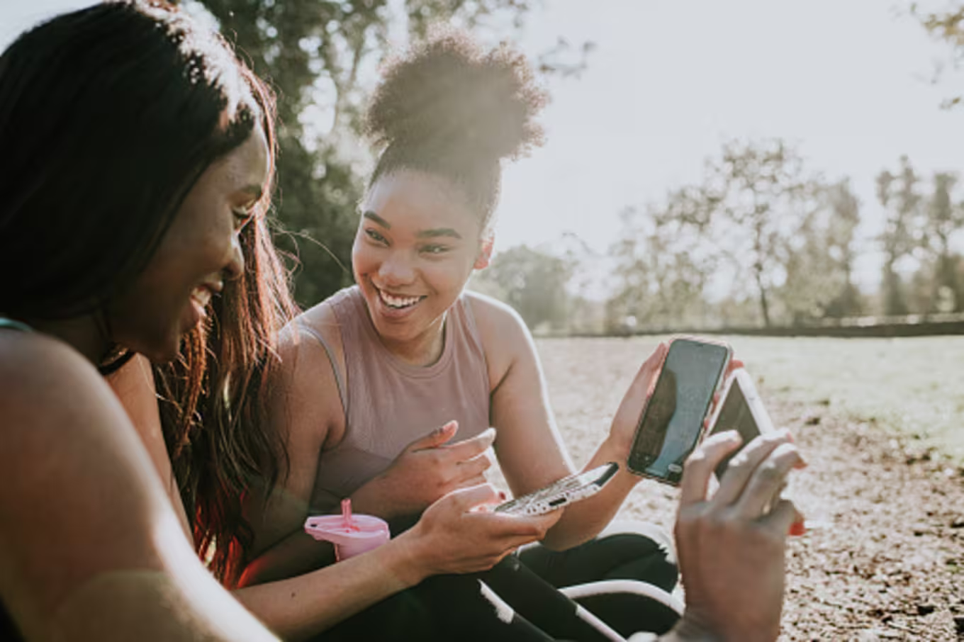 Friends laughing at cell phones demonstrating the power of influence online