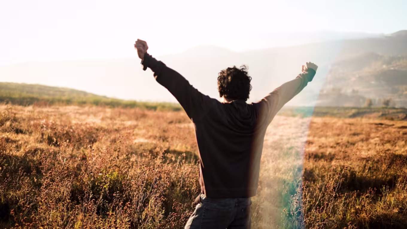 Man celebrating with his hands lifted