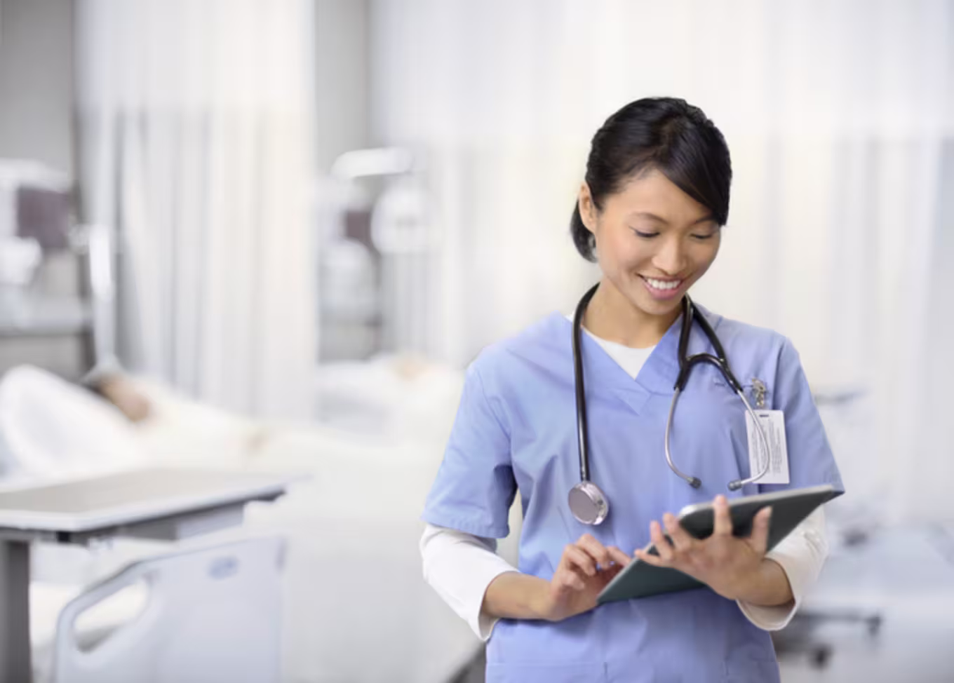 Female nurse taking notes on an electronic pad