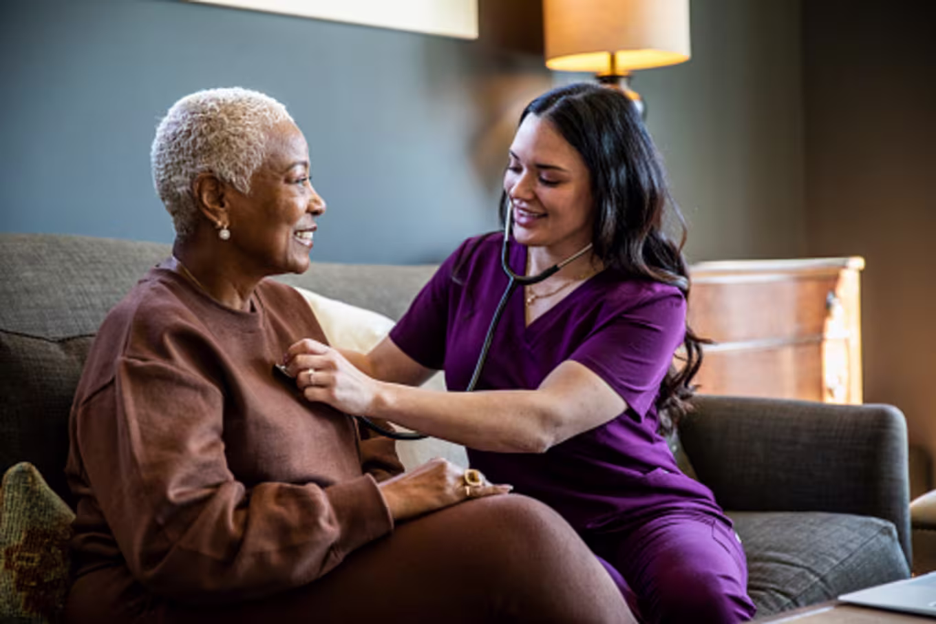 Public health nurse listening to woman&#039;s heart