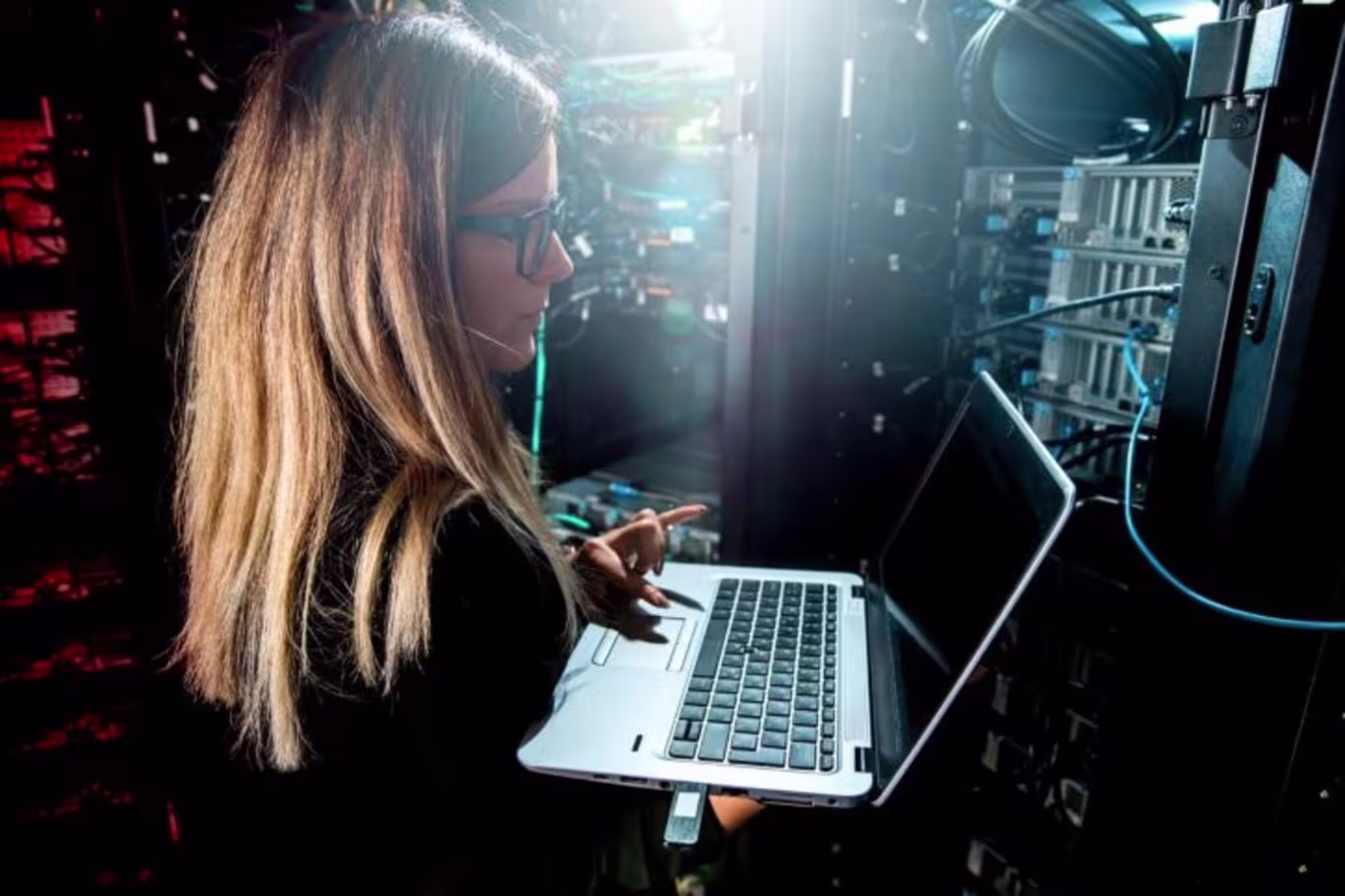 Female quality assurance analyst tests the functionality of a computer system