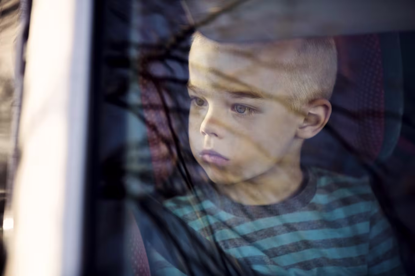 Student looking outside of car window