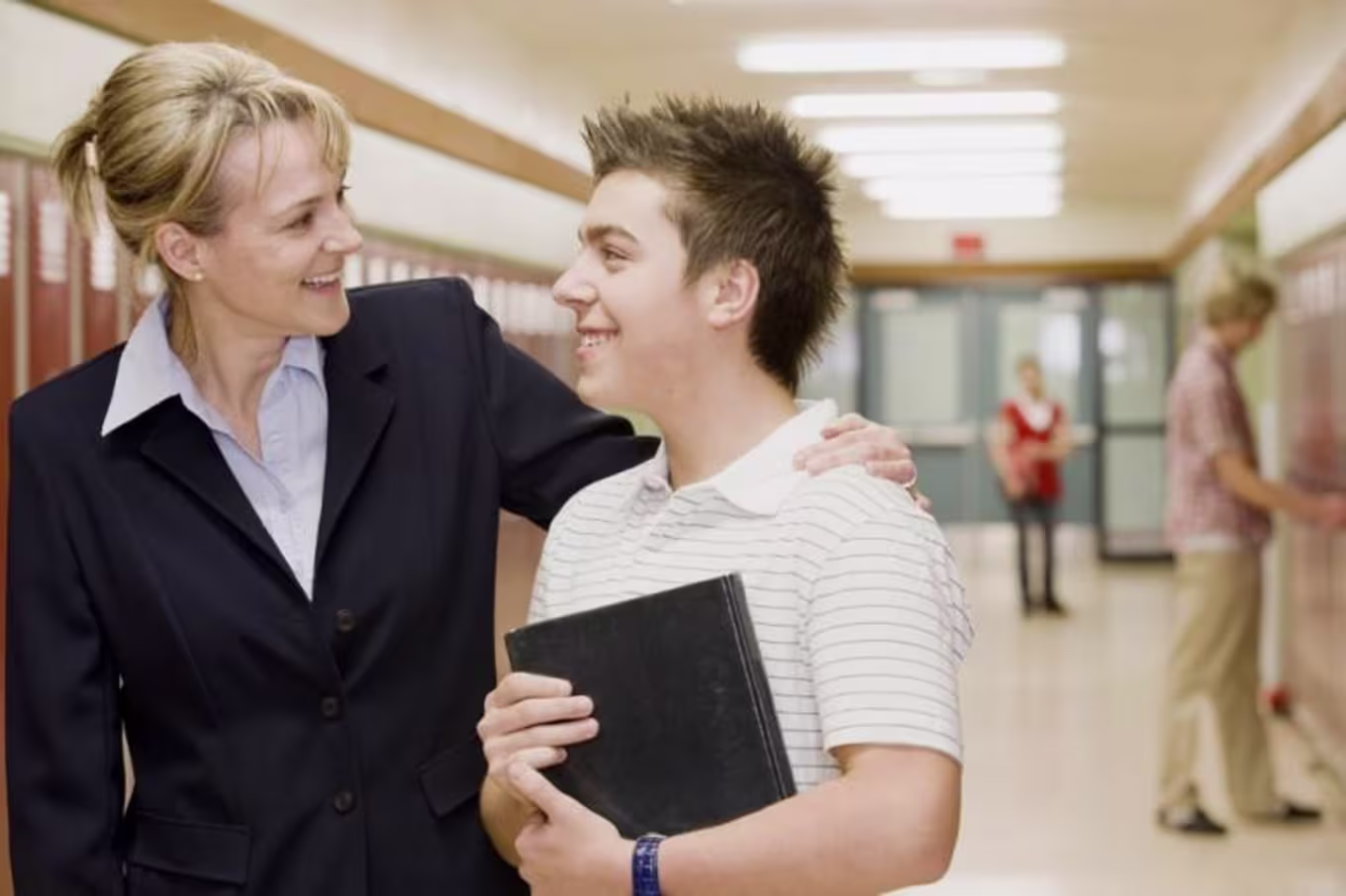 teacher with arm around student