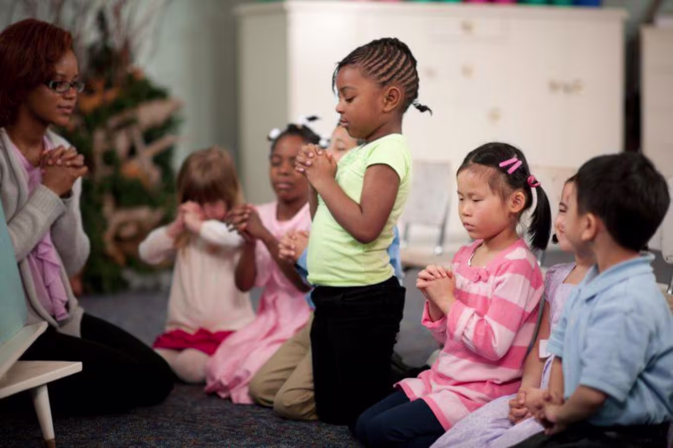 children praying in a class