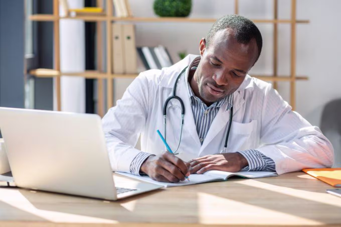 Concentrated brunette writing notes into copybook