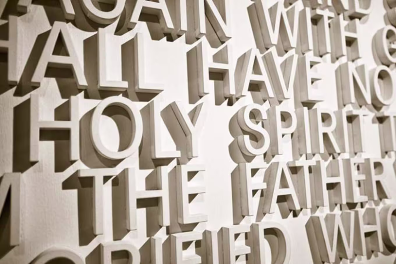"holy spirit" written with white letters on a wall