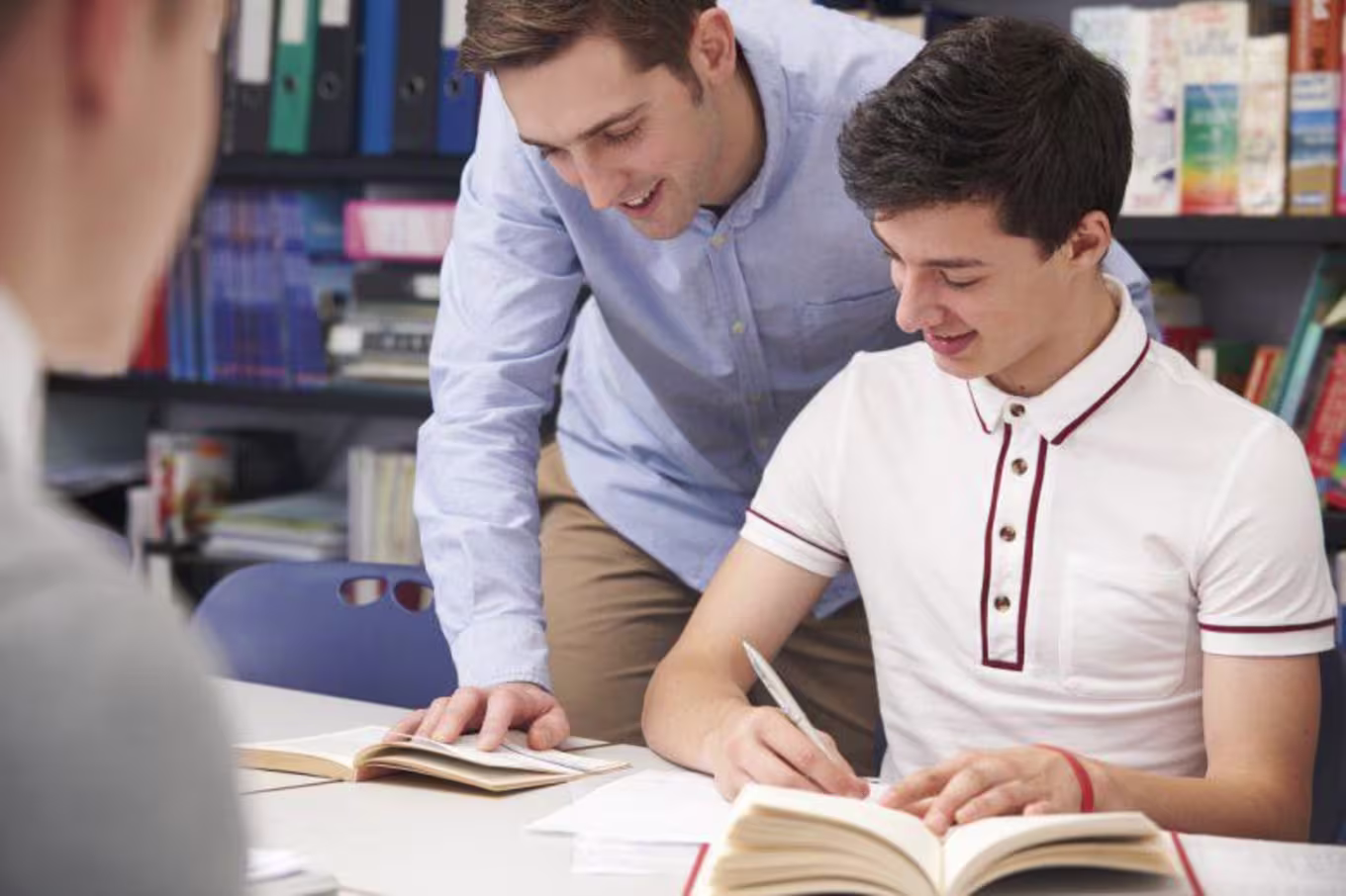 Educator helps students in classroom setting