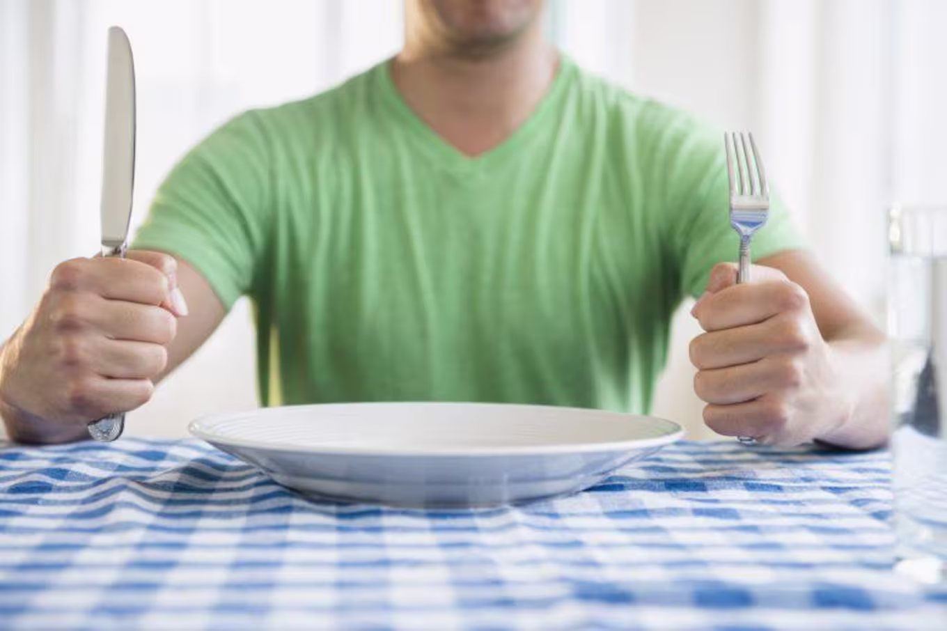 Man sitting in front of an empty plate